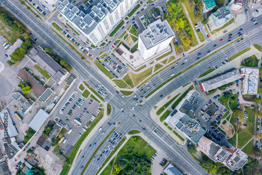 aerial top view of urban road intersection on a summer day. car traffic on city crossroad - obrazy, fototapety, plakaty 