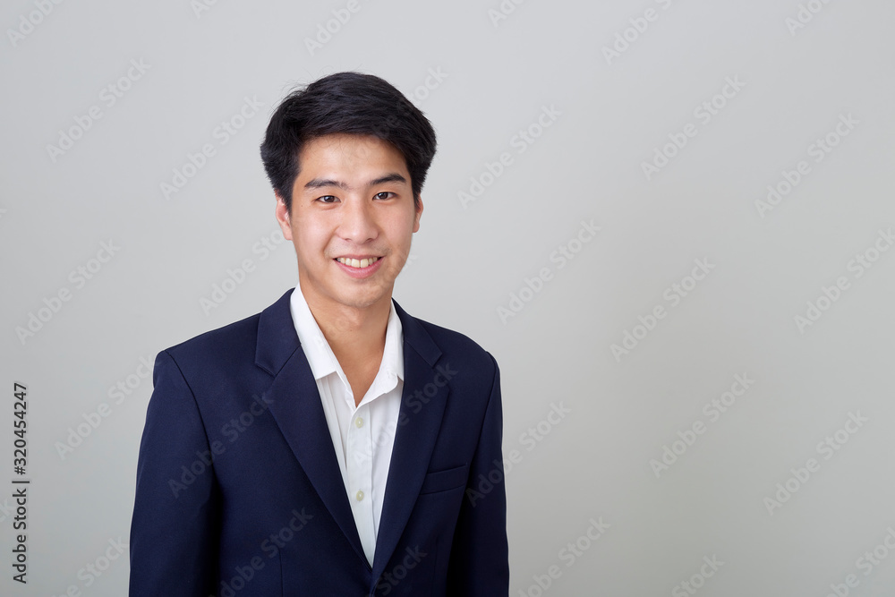 Portrait of fashionable asian businessman on bright gray Portrait of fashionable asian businessman on bright gray