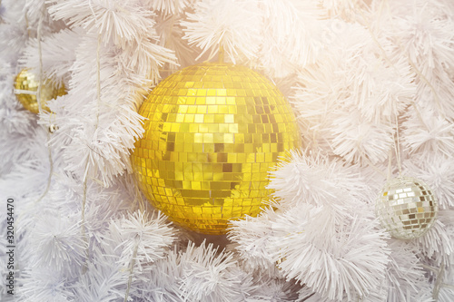 Golden Ball on White Christmas Tree