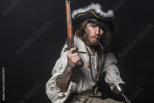 Fényképezés medieval bearded pirate with a sword and gun