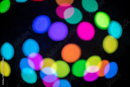 Colorful round bokeh lights at night with a black background