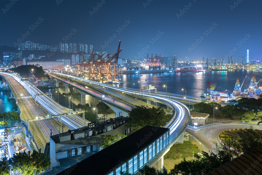Naklejka premium Cargo port and highway in Hong Kong city at night