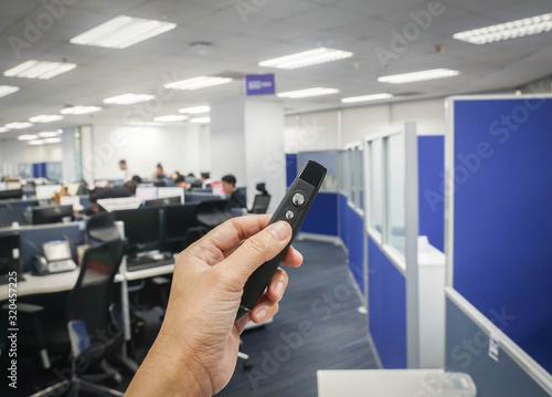 close up people hand hold wireless presentation pointer in office for meeting and conference