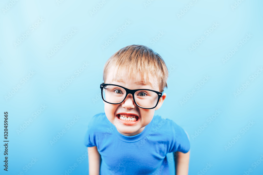 Funny boy in glasses looking at camera and show teeth, back to school. Funny boy in glasses looking at camera and show teeth, back to school.