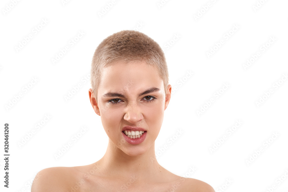 Emotional girl. Portrait of attractive half-naked blond woman with short  hair looking at camera and making angry face while standing against white  background. Snarling at the camera. Stock Photo | Adobe Stock