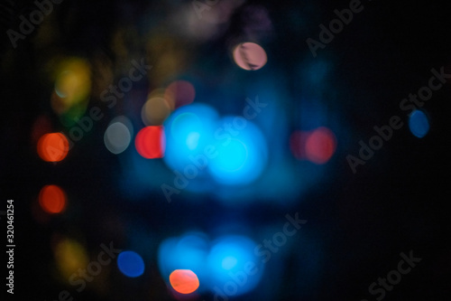 Fototapeta Defocused orbs of blue bokeh lights at night