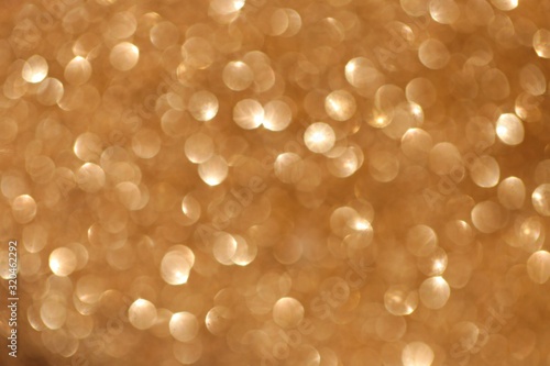 Golden shine background with golden shiny bokeh. Glitter macro shimmer texture.Vibrant background with twinkle lights. glitter brilliant mockup