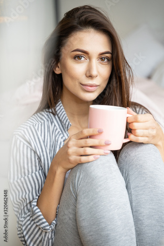 Girl with a hot drink relaxing at home
