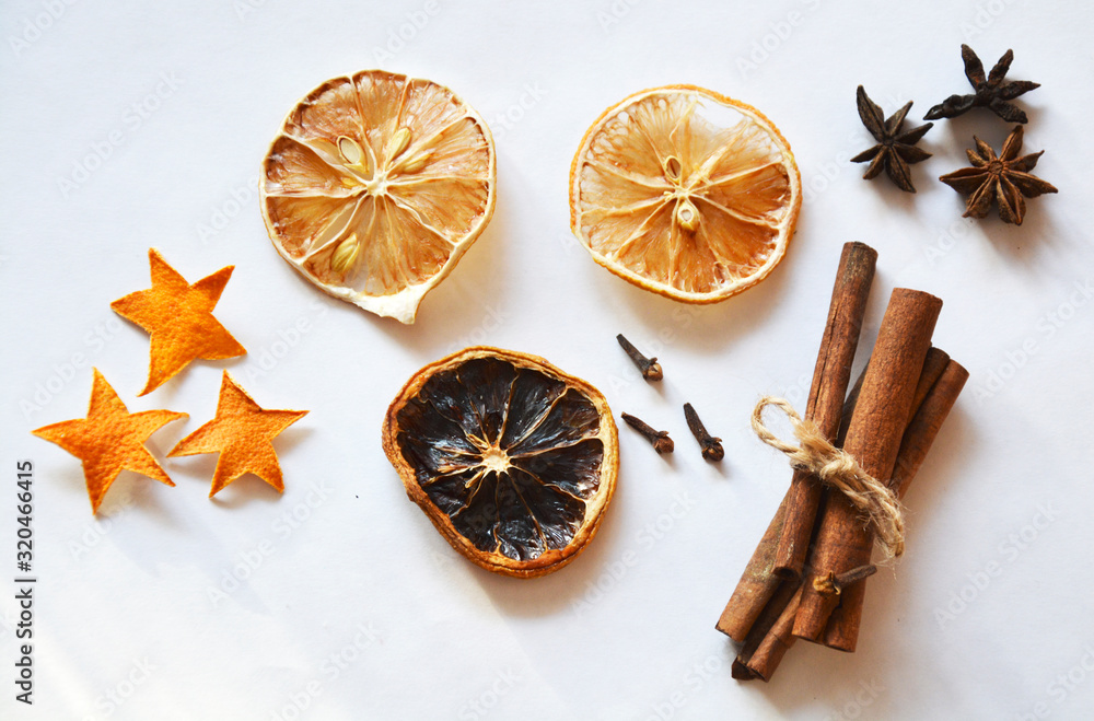 Various dry ingredients: cinnamon, dry lemon slices, clove seasoning, anise stars on a white background. Photo image. Various dry ingredients: cinnamon, dry lemon slices, clove seasoning, anise stars on a white background. Photo image.