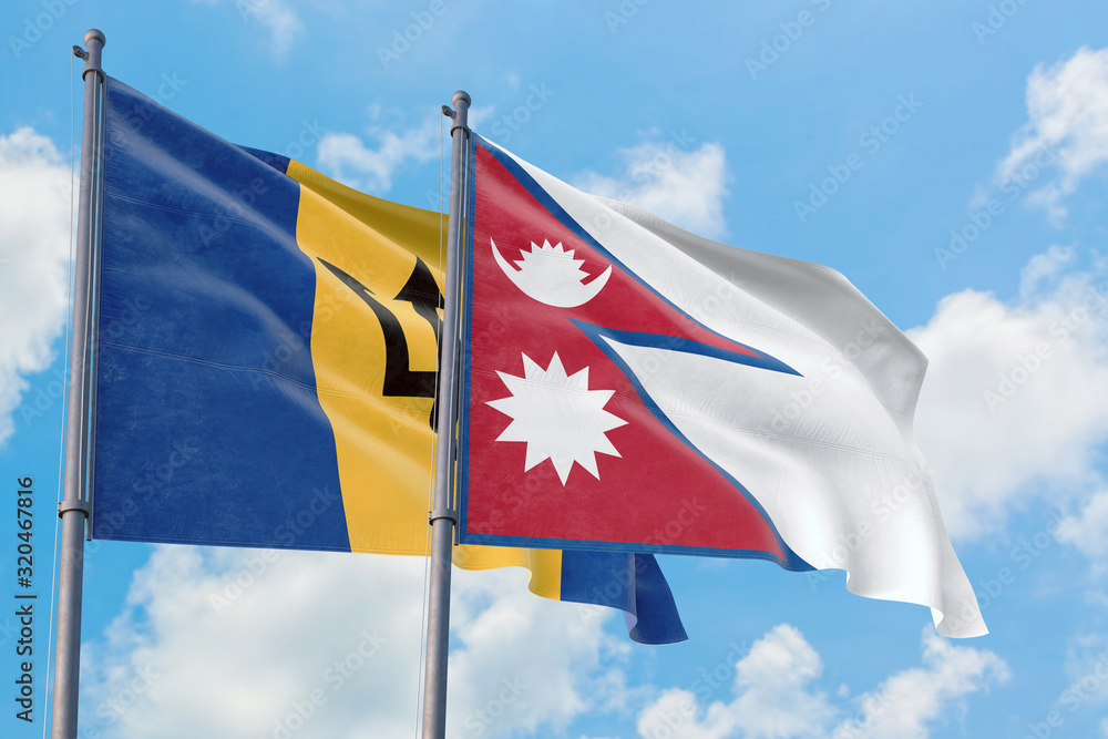 Nepal and Barbados flags waving in the wind against white cloudy blue sky together. Diplomacy concept, international relations. Nepal and Barbados flags waving in the wind against white cloudy blue sky together. Diplomacy concept, international relations.