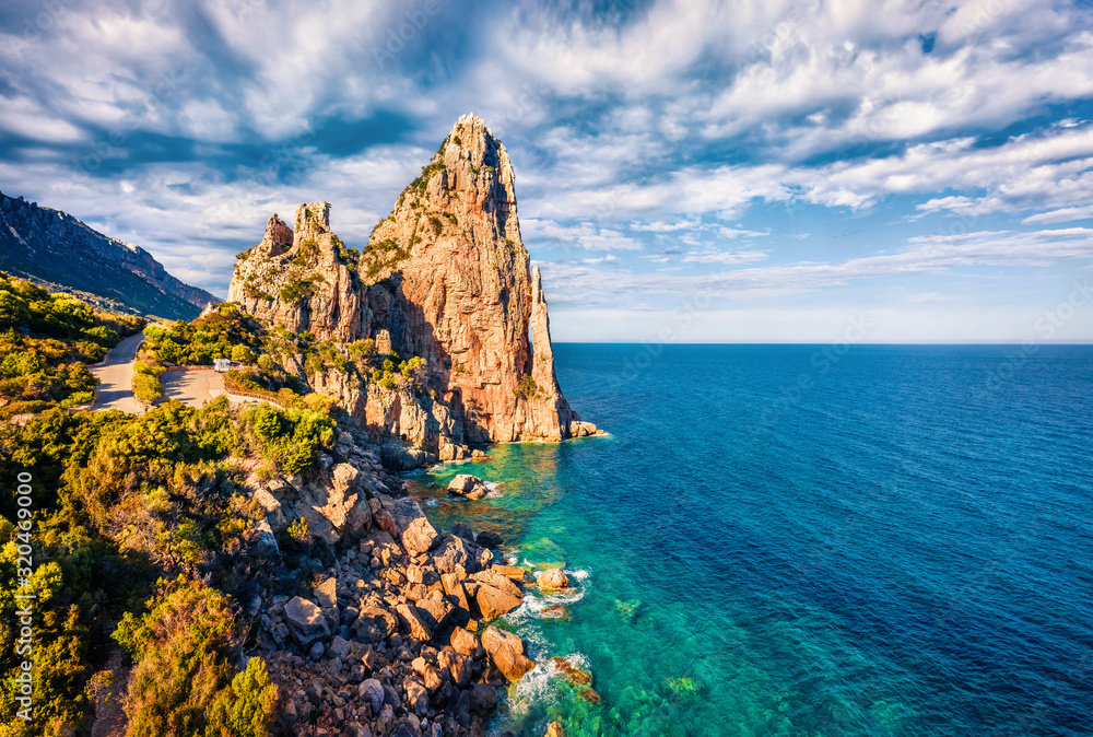 View from flying drone. Picturesque spring view of historical landmark - Pedra Longa. Dramatic morning scene of Sardinia island, Italy, Europe. Splendid Mediterranean seascape.