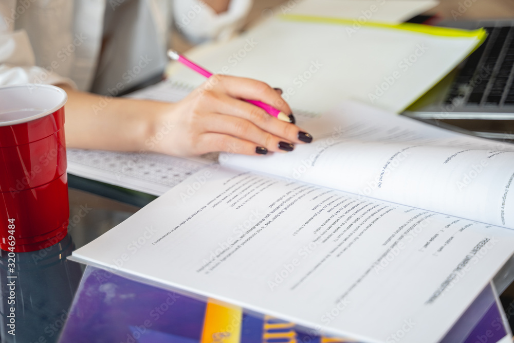 Cropped photo of woman working with papers and laptop Cropped photo of woman working with papers and laptop