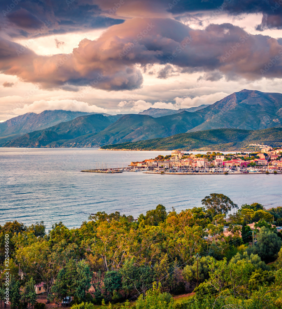 Dramatic spring view of Saint-Florent port, Haute-Corse department of France, Europe. Gorgeous sunset on Corsica island. Colorful seascape of Mediterranean sea. Traveling concept background...