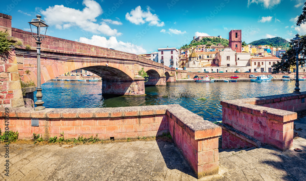 Sunny spring cityscape of Bosa town with Ponte Vecchio bridge across the Temo river. Captivating morning view of Sardinia island, Italy, Europe. Traveling concept background..