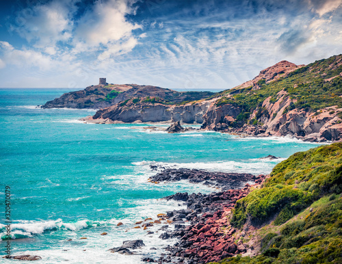 Astonishing spring view of Torre Argentina tower. Sunny morning scene of Sardinia island, Italy, Europe. Wonderful seascape of Mediterranean sea. Beauty of nature concept background..