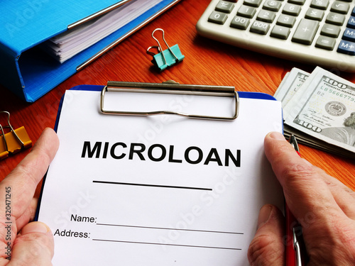 Microloan application form with money for lending. photo