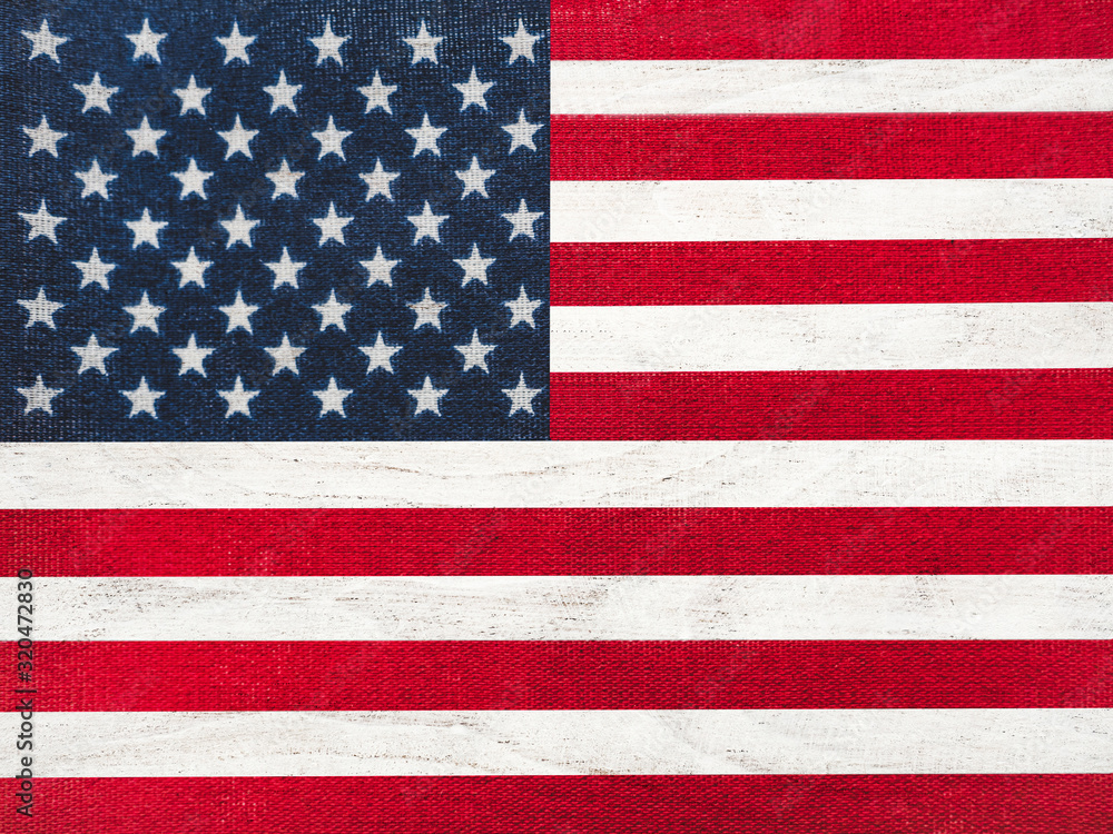 Fototapeta premium American Flag lying on the table. Place for your inscriptions. Top view, close-up. National holiday concept