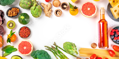 Food panorama with copy space, a flat lay of fruits, vegetables, nuts, wine, and cheese, pasta and mushrooms, forming a frame. A design template for a menu or grocery shop