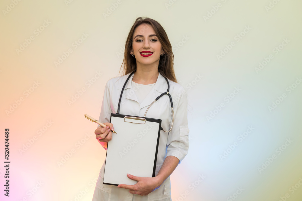 Doctor holding clipboard with pen. Pretty woman in medical form smiling Doctor holding clipboard with pen. Pretty woman in medical form smiling
