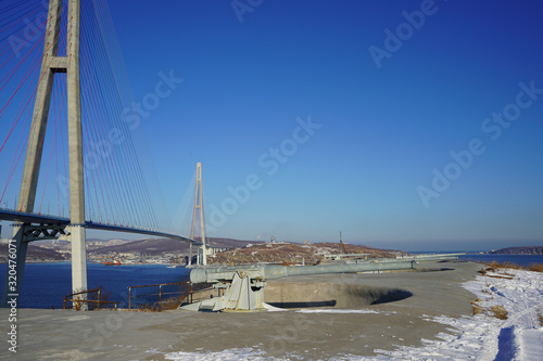 Landscape with a view of the Russian bridge against the blue sky. photo