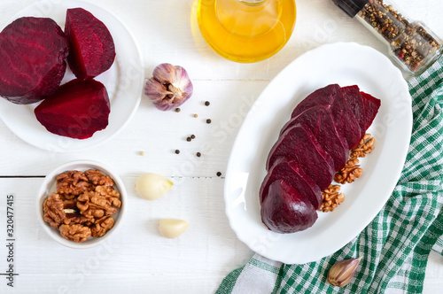 Slices of boiled beets on a white plate. Source of energy. Dietary healthy vegetable. Top view.