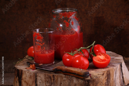 Still life with tomato juice on a wooden table