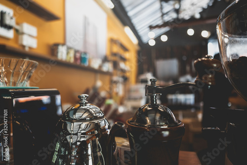 Coffee maker on blur coffee shop background