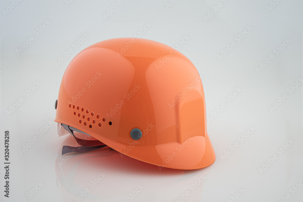 Fototapeta premium Orange safety helmet construction on white background