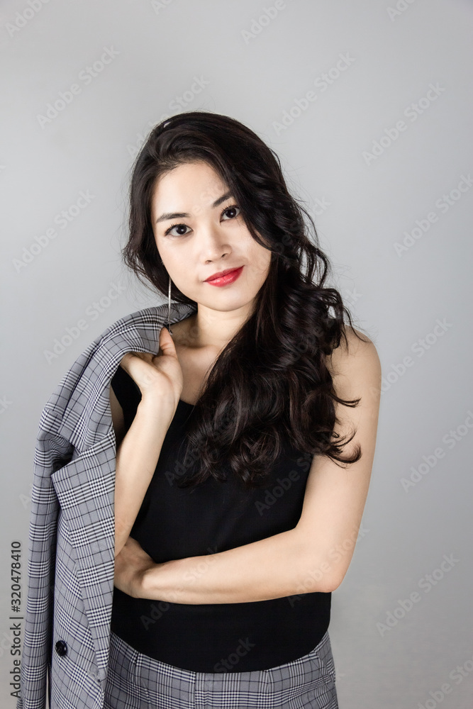 portrait of a Chinese woman holding jacket over shoulder portrait of a Chinese woman holding jacket over shoulder