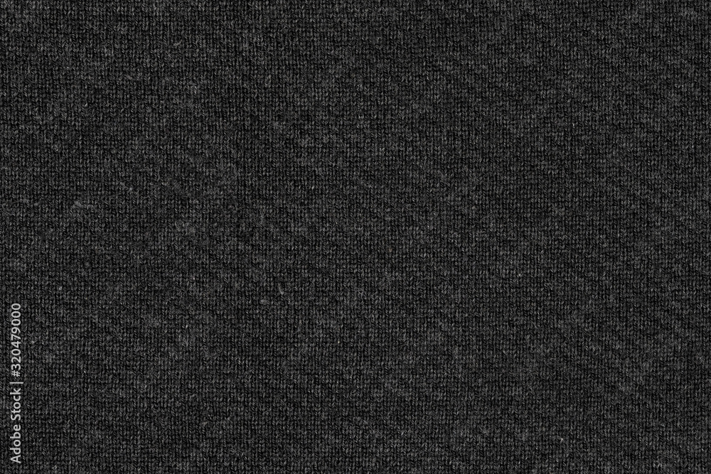 Black natural texture of knitted wool textile material background. dark gray cotton fabric woven canvas texture