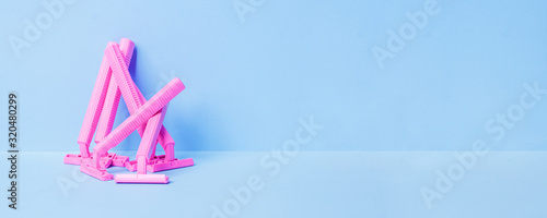 Concept of woman female shaving: pink razer on blue background, copy space, advertizing, coupon flyer creative idea, hygiene bodycare, depilation equipment, magazine, sale, pop art style, banner photo