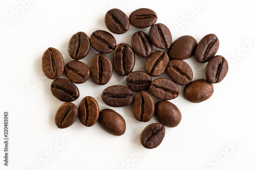 Coffee beans scattered on a white background top view