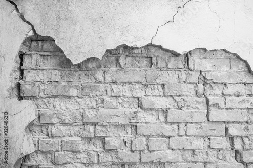 Old wall of bricks with chapped plasterwork. Abstract background 