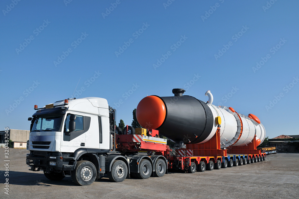 Oversize truck with multiple wheels and tank - obrazy, fototapety, plakaty 