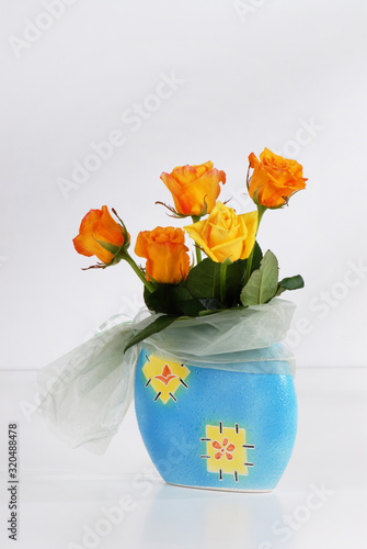 Bouquet of beautiful yellow roses on light gray background