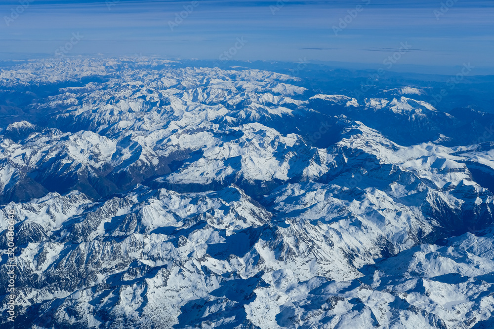 Aerial view of the entire Pyrenees mountains range on a beautiful winter afternoon  