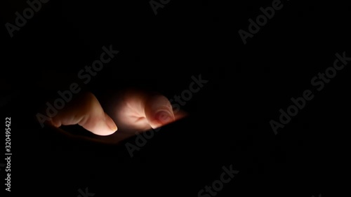 Woman typing text message on smartphone at night