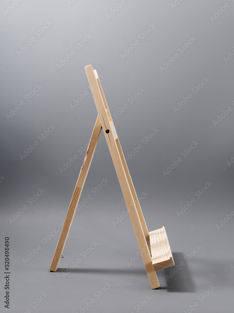 easel made of wood table on a gray background easel made of wood table on a gray background