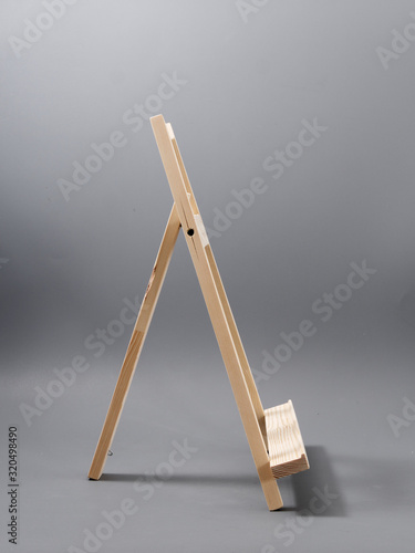 easel made of wood table on a gray background