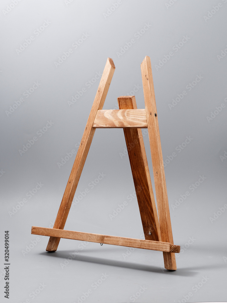 easel made of wood table on a gray background easel made of wood table on a gray background
