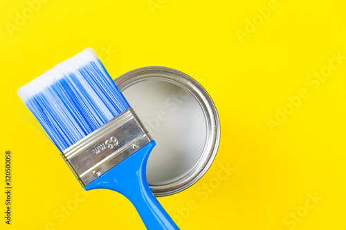 White Paint Can with Brush Top View On Yellow Background. - Image