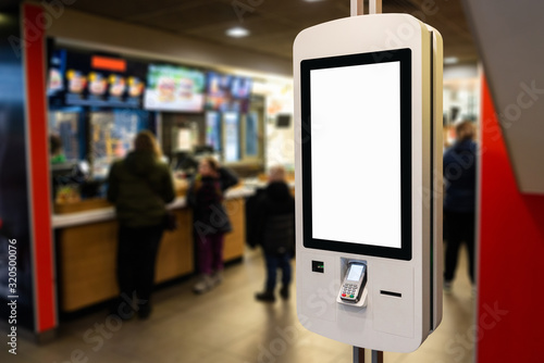 Self-service desk with touch screen in fast food restaurant