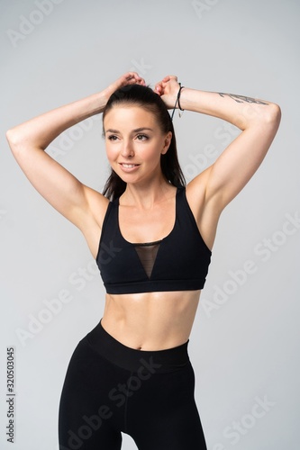 Attractive young adult in sportswear posing on white background. © opolja