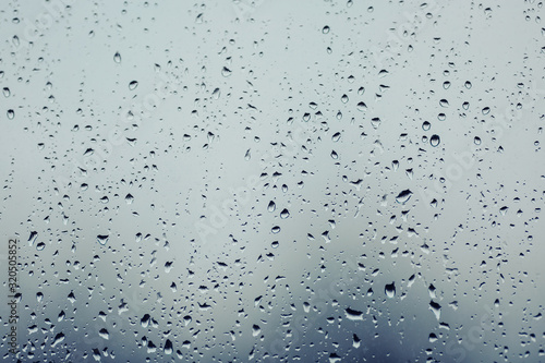 Close up of water droplets on glass. Window with rain drops. 