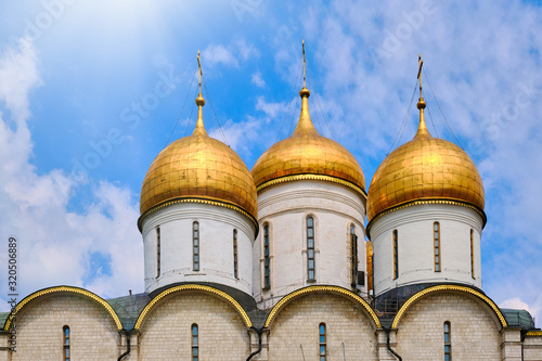 Domes of the Assumption Cathedral against the sky with clouds - Kremlin, Moscow, Russia in June 2019
