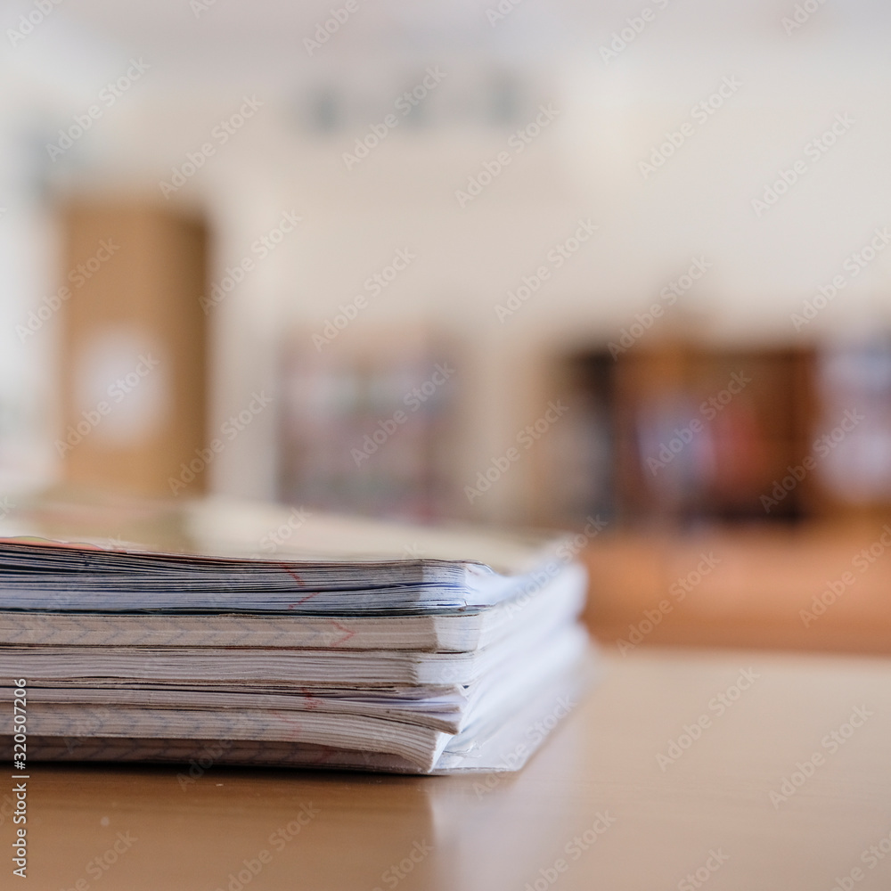 Interior of an empty school class with notebooks on a frontground Interior of an empty school class with notebooks on a frontground
