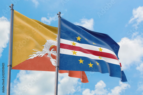 Cape Verde and Bhutan flags waving in the wind against white cloudy blue sky together. Diplomacy concept, international relations.