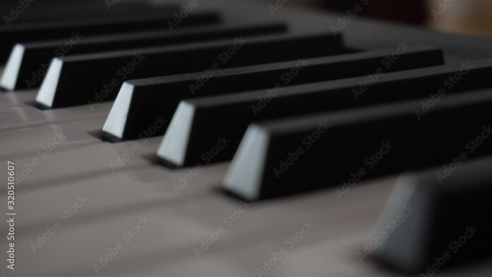 4k dusty video of slowly moving or panning piano keys close up macro shot. Musical instrument. Music concept creative idea. Slow movement from right to left 4k dusty video of slowly moving or panning piano keys close up macro shot. Musical instrument. Music concept creative idea. Slow movement from right to left
