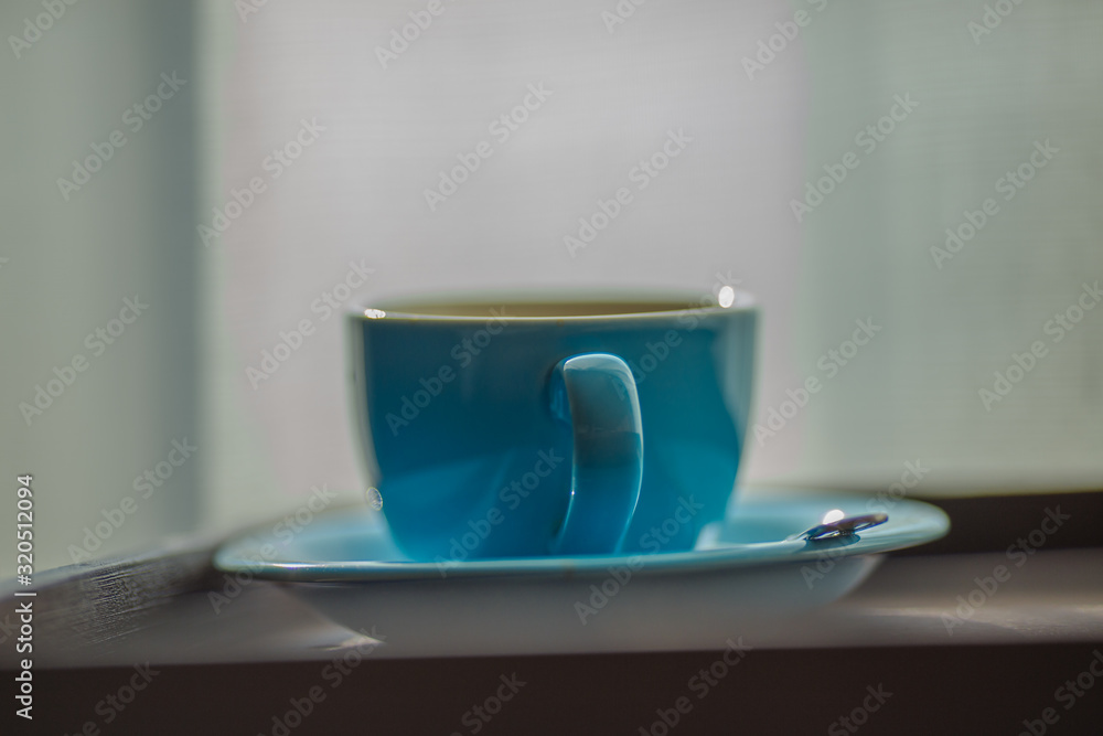 Blurred background view of a mug or coffee cup, a cup of water or a drink on the table, for customer service in a room or restaurant Blurred background view of a mug or coffee cup, a cup of water or a drink on the table, for customer service in a room or restaurant