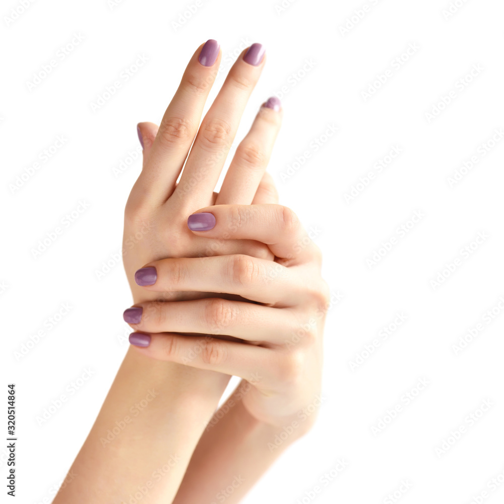 Closeup of hands of a young woman with pink manicure on nails against white background Closeup of hands of a young woman with pink manicure on nails against white background